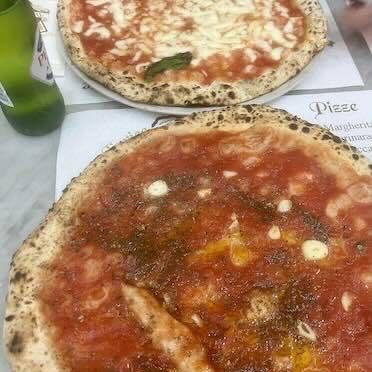 A marinara and a margherita served on the counter at Da Michele in Naples