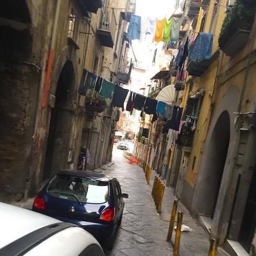 A narrow Naples side street with laundry strung between the buildings